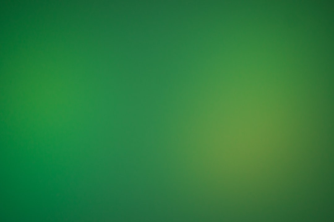 a blurry green background with a white border
