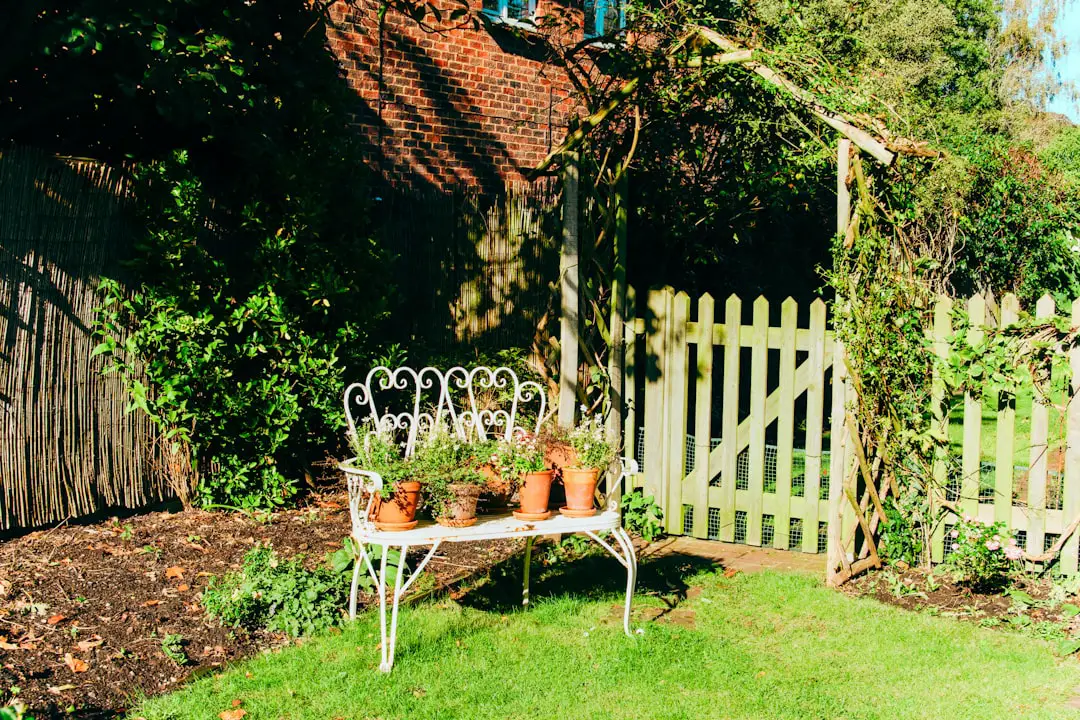 a white bench sitting in the middle of a garden